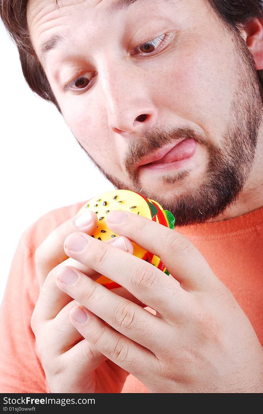 A young adult is about to eat a burger. A young adult is about to eat a burger