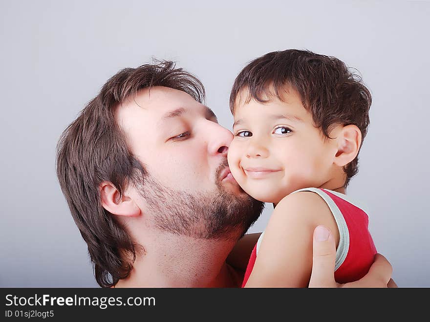 Lovely father is holding a little boy in his arms. Lovely father is holding a little boy in his arms