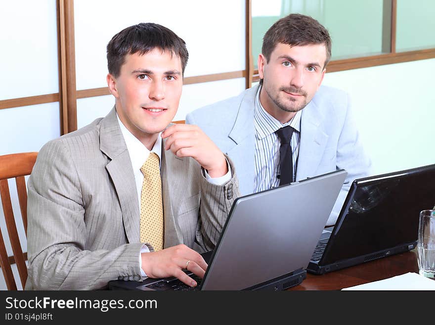 Business theme: business people in a work process in office. Business theme: business people in a work process in office.