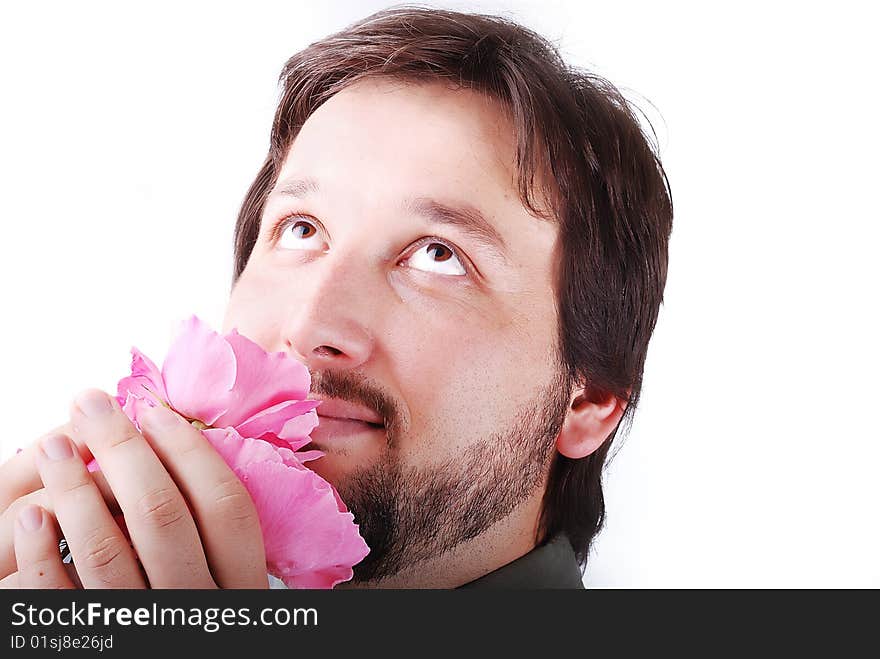 Cute man smeling pink roses and smiling