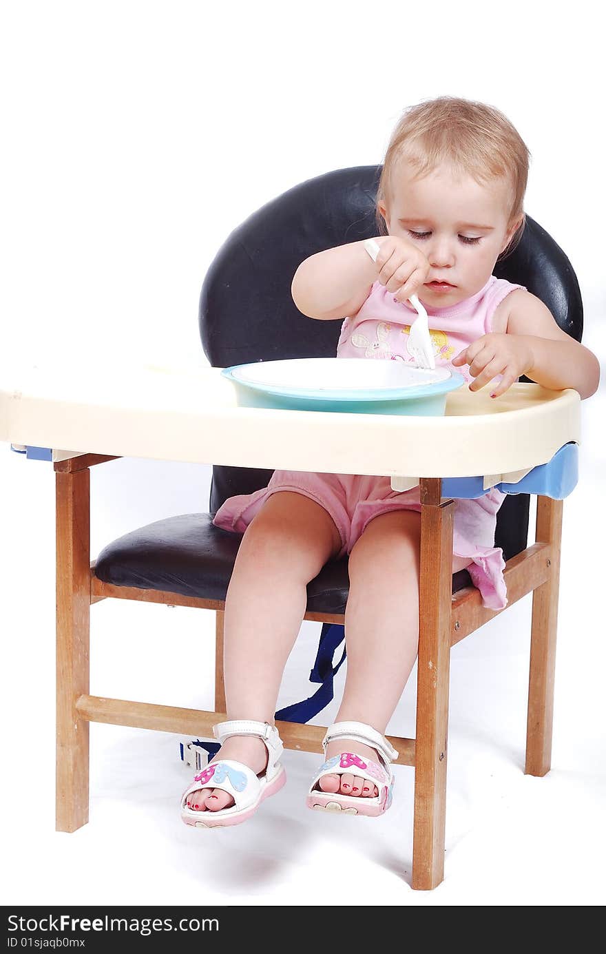 the Baby sitting on the black chair isolated in white