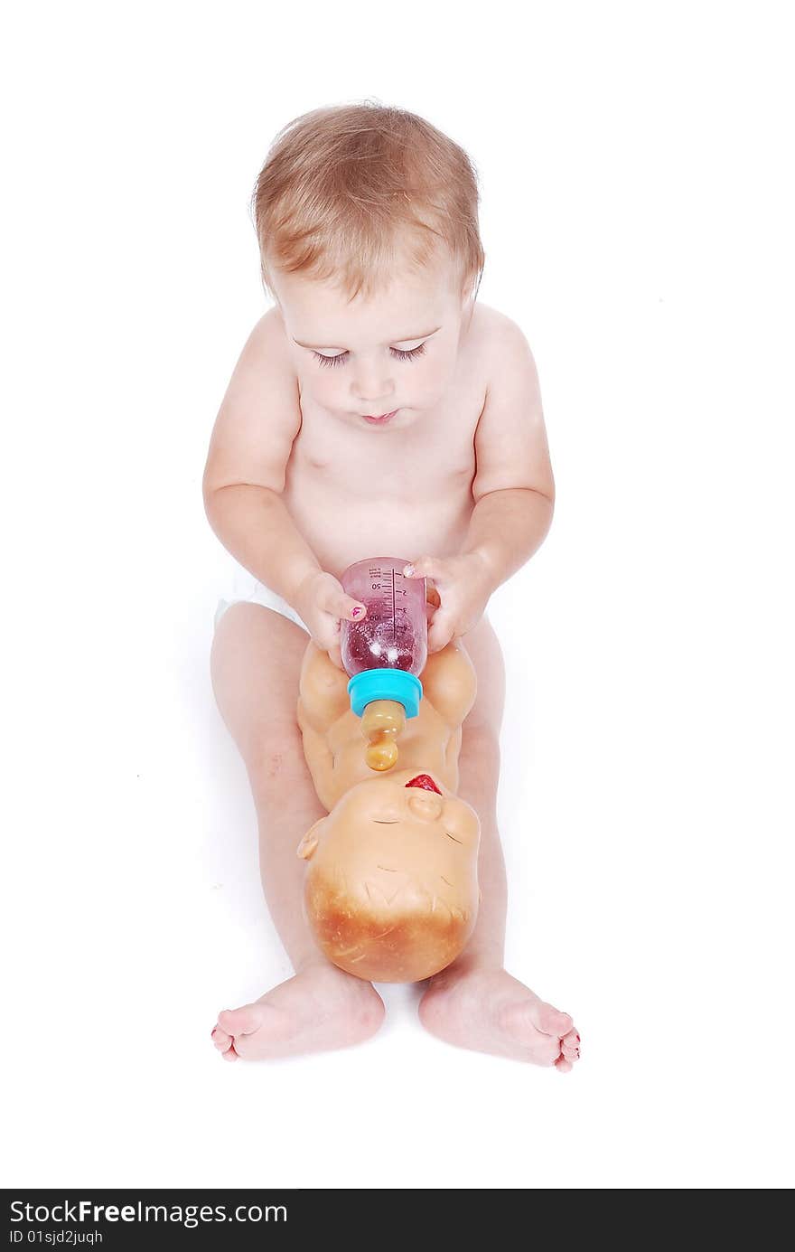 Baby feeding a toy baby