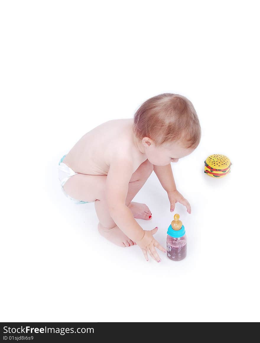 Baby between hamburger and drinking bottle