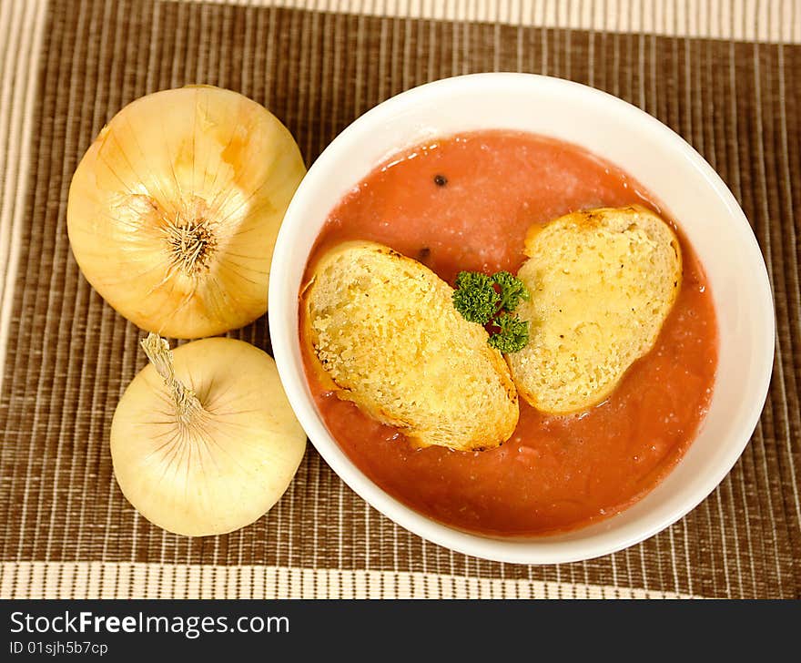 Onion and tomato soup with baguette bread. Onion and tomato soup with baguette bread