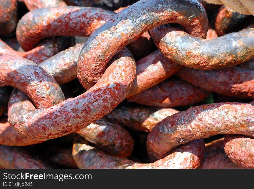 Old rusty massive iron chain texture on sunlight