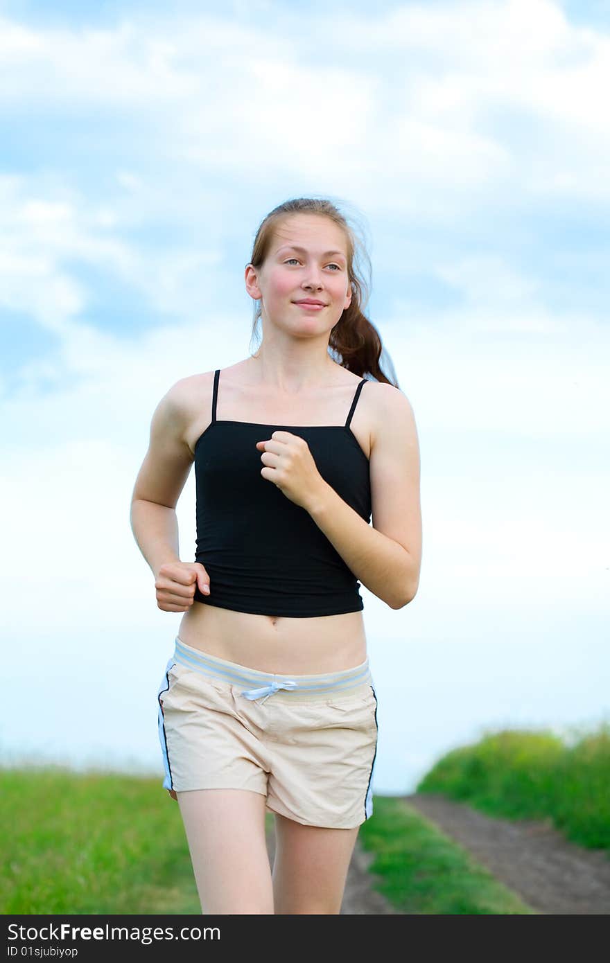 Woman run on green grass under sky