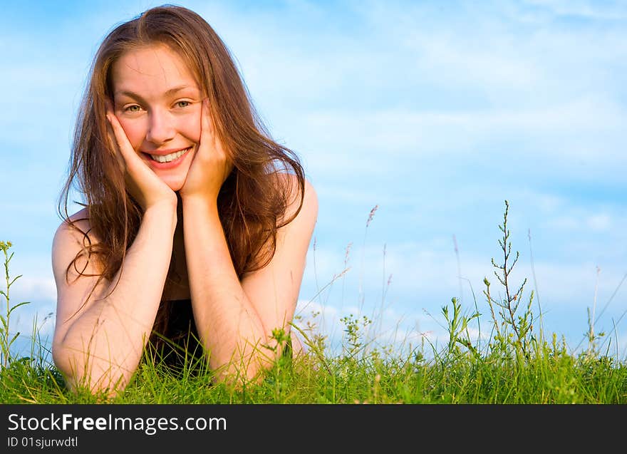 Young Woman Lying On The Green Grass