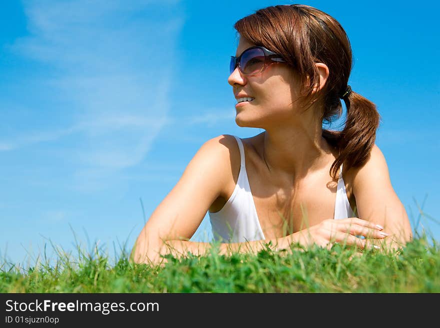 Young woman lying on the green grass