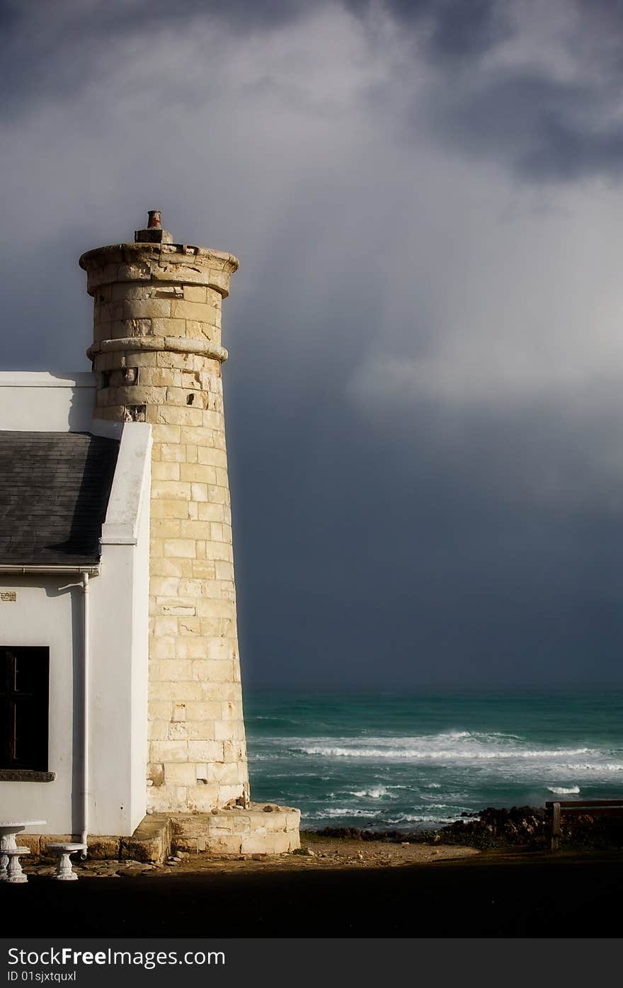 Tower on the shores of the Atlantic Ocean. South Africa. Dark sky (after the storm). Tower on the shores of the Atlantic Ocean. South Africa. Dark sky (after the storm).