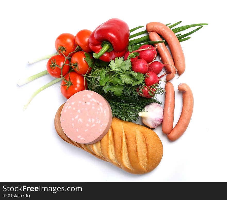 The food - paprika, sausages, wurst, bread,  tomatoes, fennel, garden radish and garlic