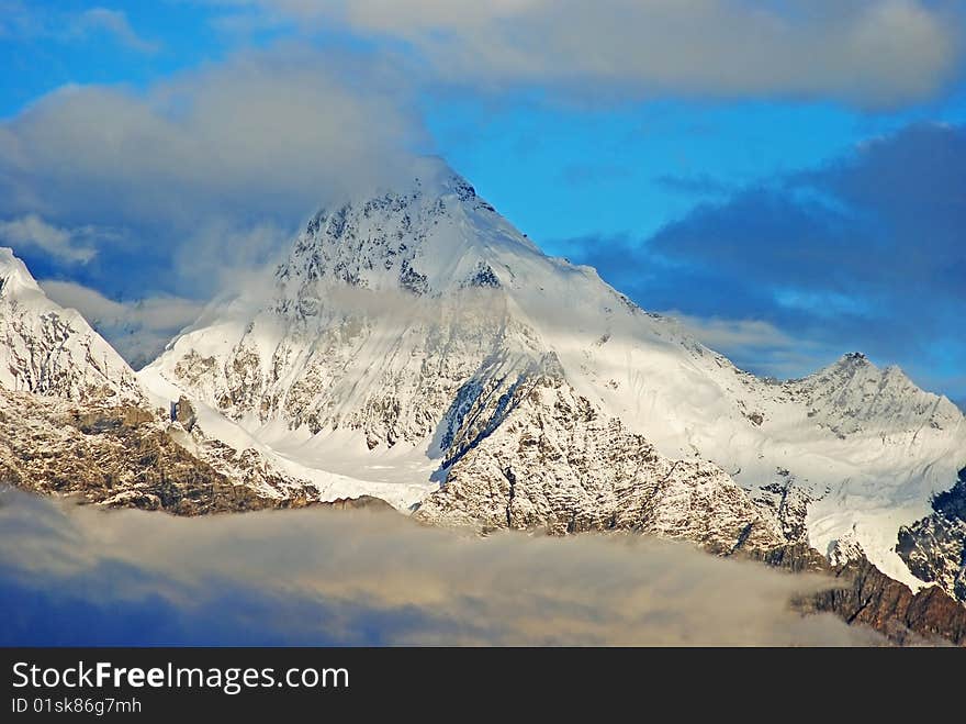 A high snowy mountain peak in china. A high snowy mountain peak in china