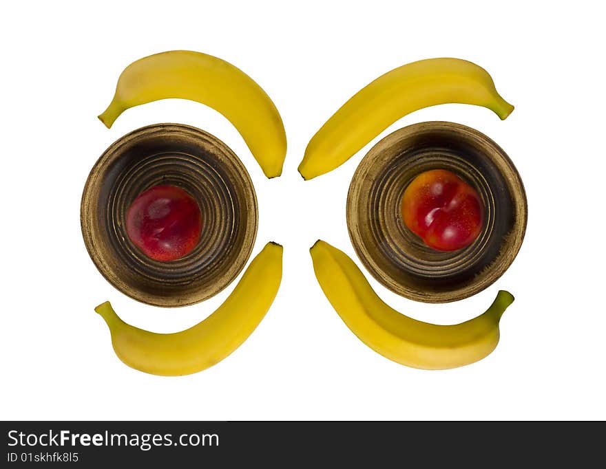 Bananas and peaches on plates isolated over white background