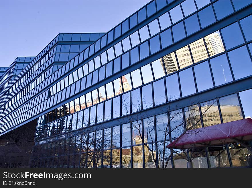 Blue glass building with reflections and many angles