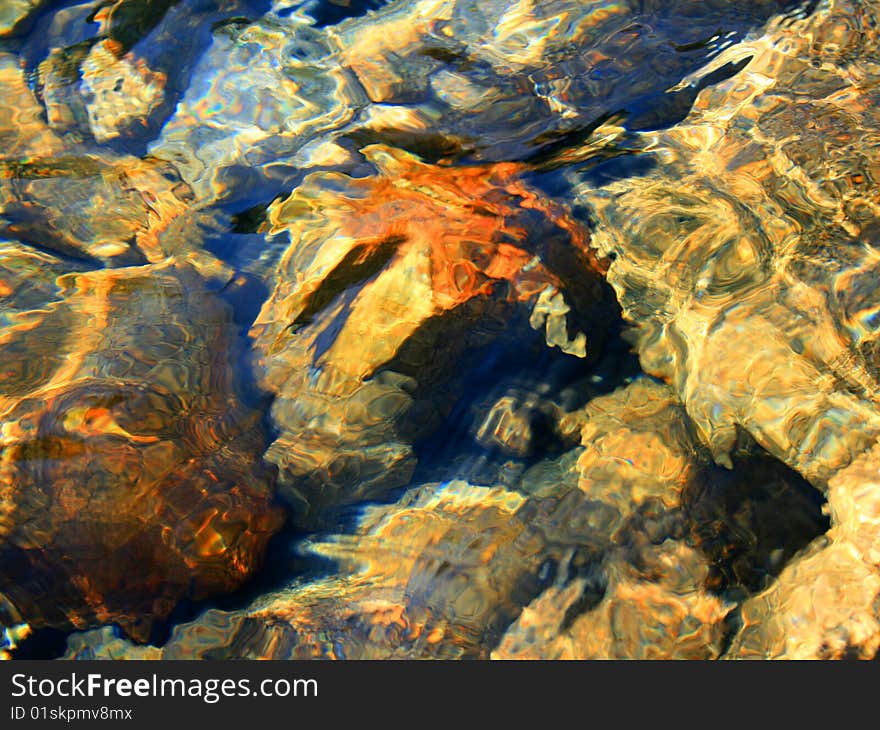 Stones from a lake with water reflection. Stones from a lake with water reflection