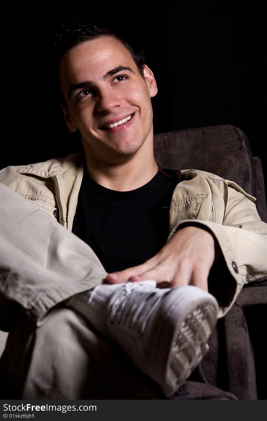 Young man smiling, isolated on black