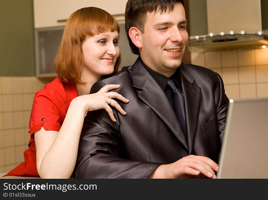 Happy couple in kitchen with laptop. Happy couple in kitchen with laptop