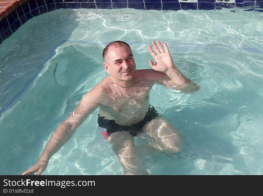 Man poses in pool