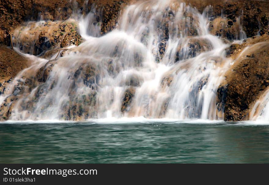 Close view of a lake and waterfall. Close view of a lake and waterfall.