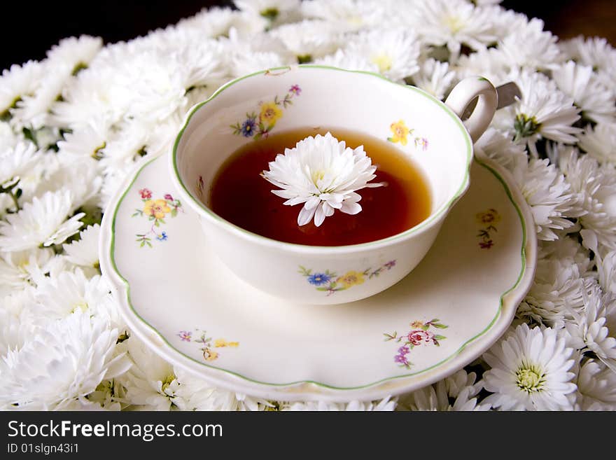 Cup of tea in flowers surrounding