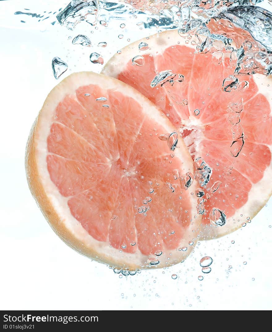 Red grapefruit in water. Creative fruit and bubbles water