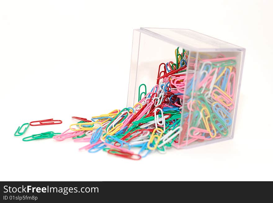 Paperclips spilled over in a container.