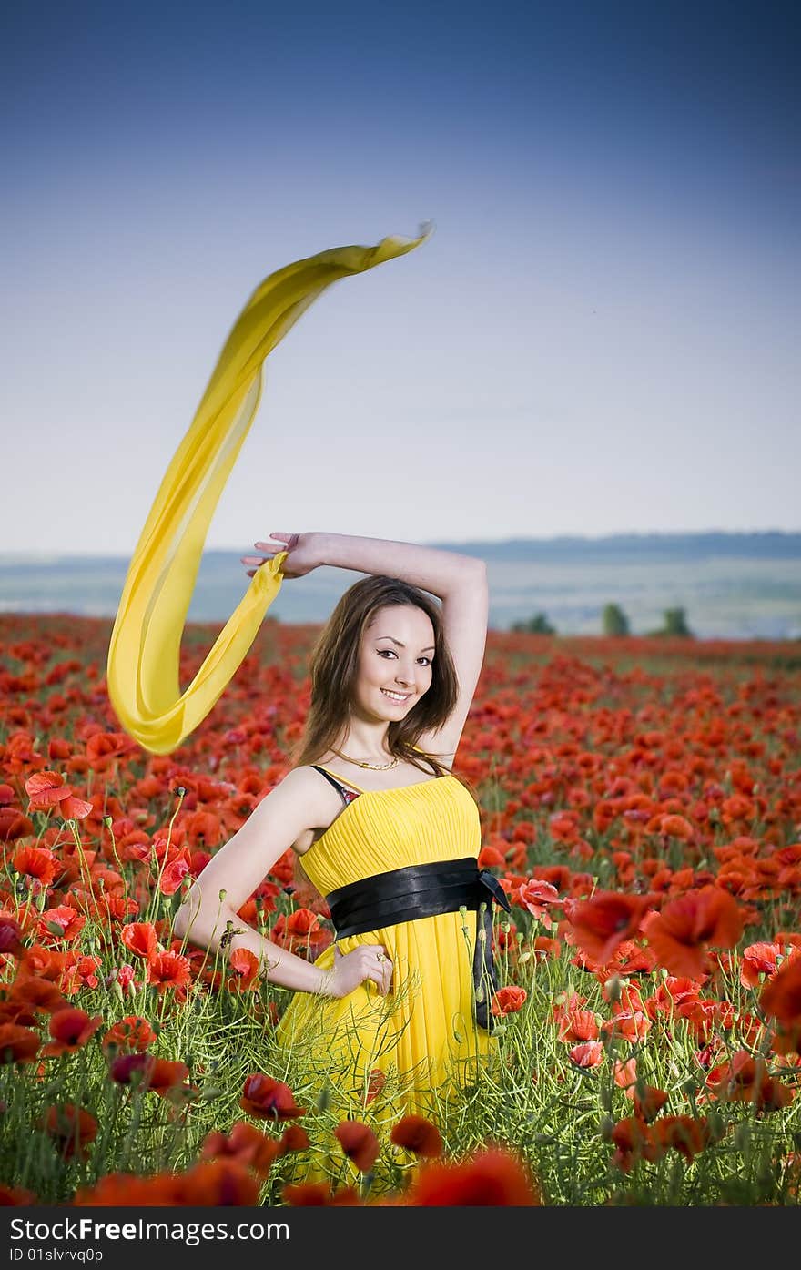 Attractive girl in the poppy field