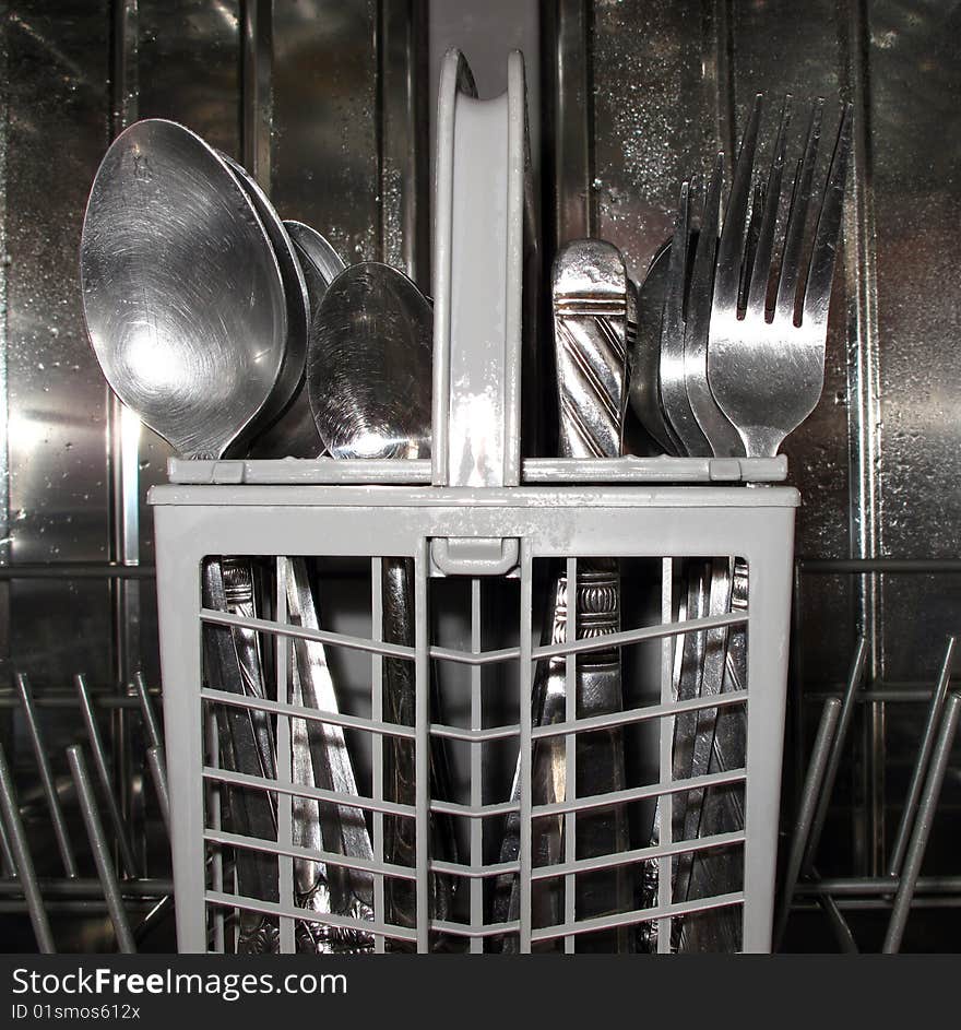 Close-up of utlery basket in dishwasher. Close-up of utlery basket in dishwasher