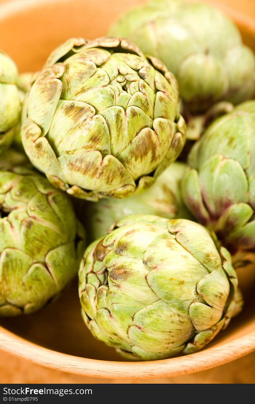 Baby artichokes in wooden bowl