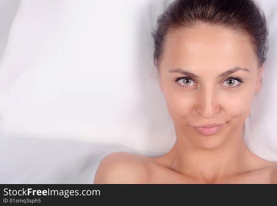 Portrait of the playful beautiful girl on a white background