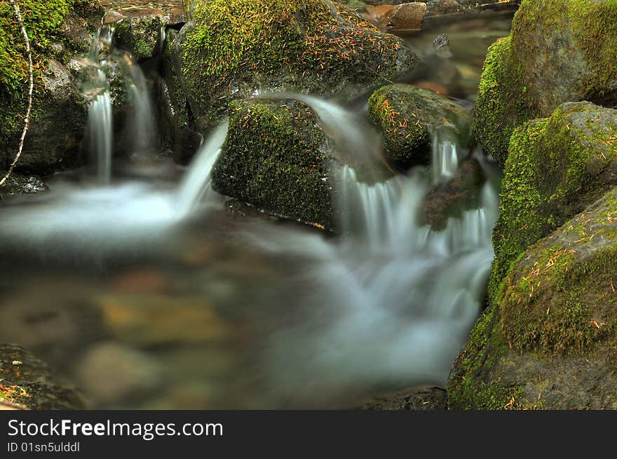 Beautiful waterfall flowing through a creek in summer