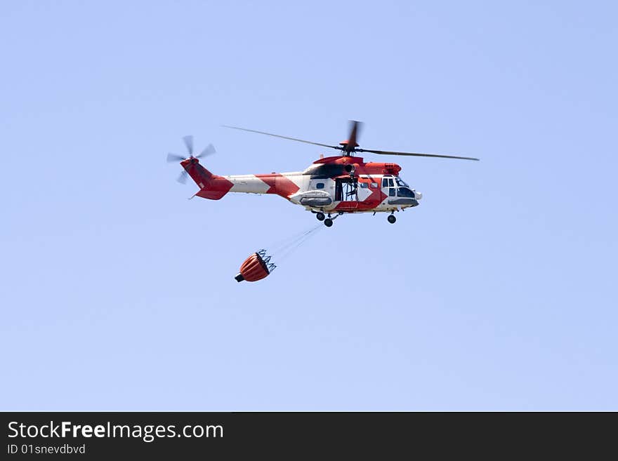 A South African Air Force Oryx firefighting helicopter with a fire bucket at Ysterplaat Air Force Base Cape Town South. A South African Air Force Oryx firefighting helicopter with a fire bucket at Ysterplaat Air Force Base Cape Town South