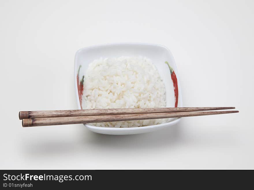 A bowl of perfectly cooked, plain Basmati rice, in an Asian style bowl, with a garnish of Thai Basil. A bowl of perfectly cooked, plain Basmati rice, in an Asian style bowl, with a garnish of Thai Basil