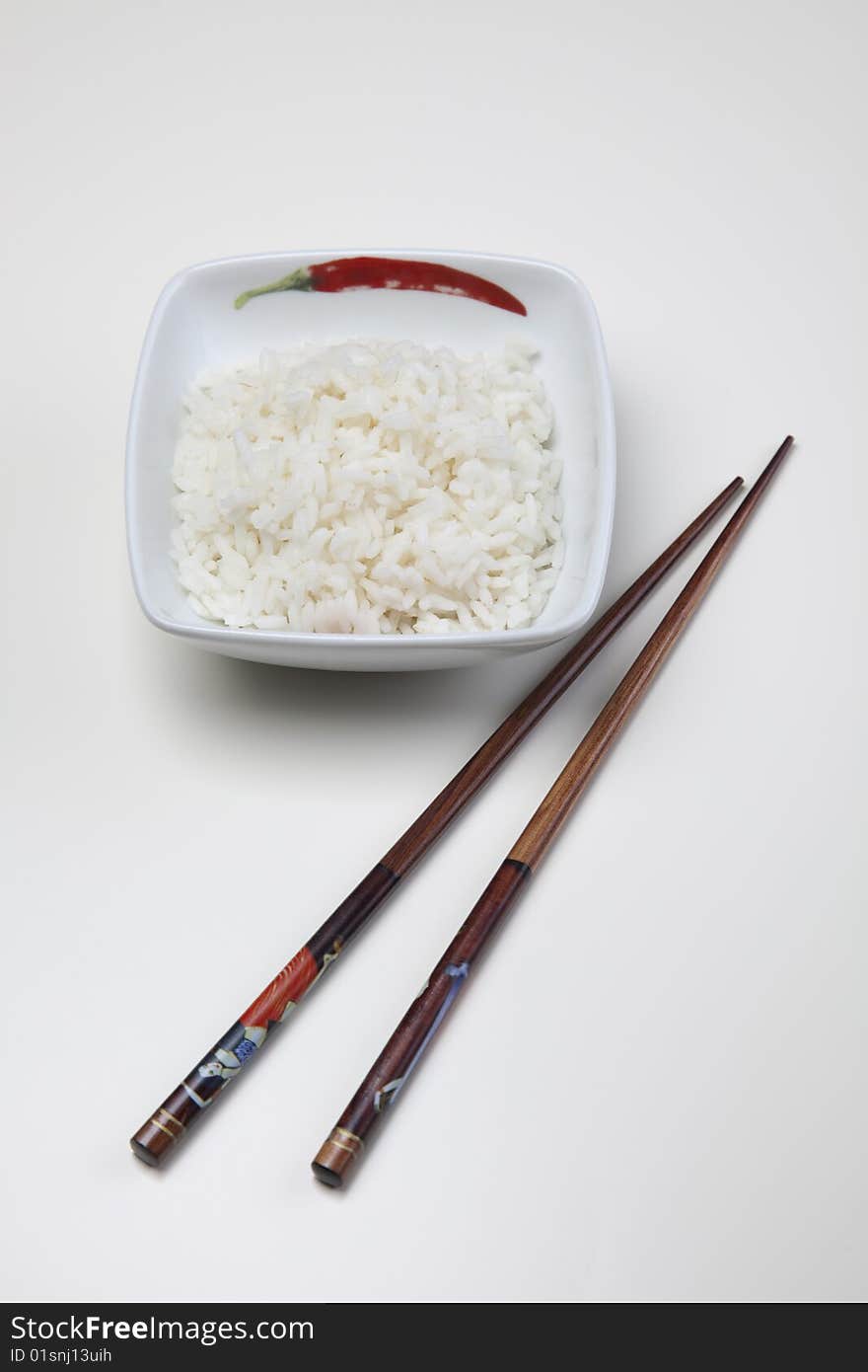 A bowl of perfectly cooked, plain Basmati rice, in an Asian style bowl, with a garnish of Thai Basil. A bowl of perfectly cooked, plain Basmati rice, in an Asian style bowl, with a garnish of Thai Basil