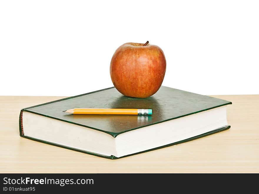 Apple And Pencil On Top Of Book