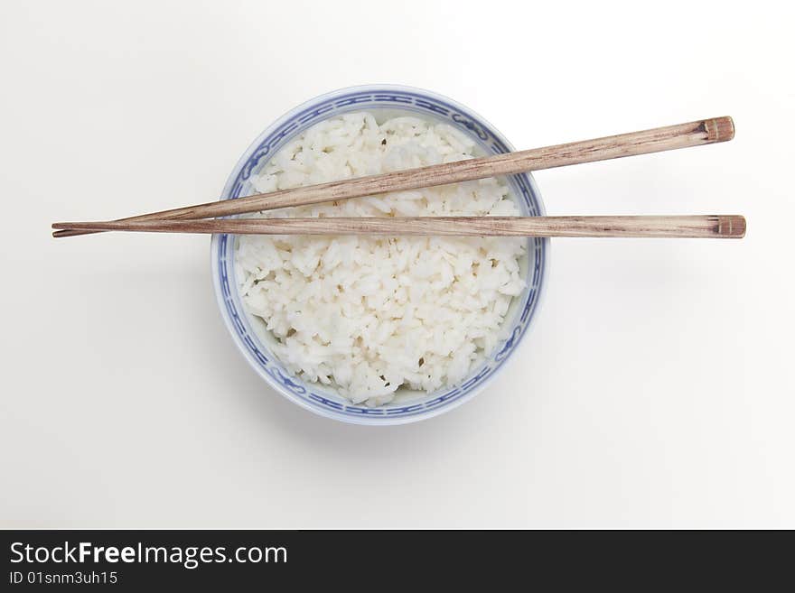 A bowl of perfectly cooked, plain Basmati rice, in an Asian style bowl, with a garnish of Thai Basil. A bowl of perfectly cooked, plain Basmati rice, in an Asian style bowl, with a garnish of Thai Basil