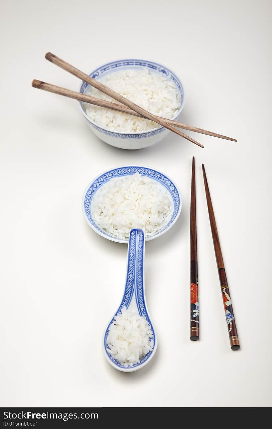 A bowl of perfectly cooked, plain Basmati rice, in an Asian style bowl, with a garnish of Thai Basil. A bowl of perfectly cooked, plain Basmati rice, in an Asian style bowl, with a garnish of Thai Basil