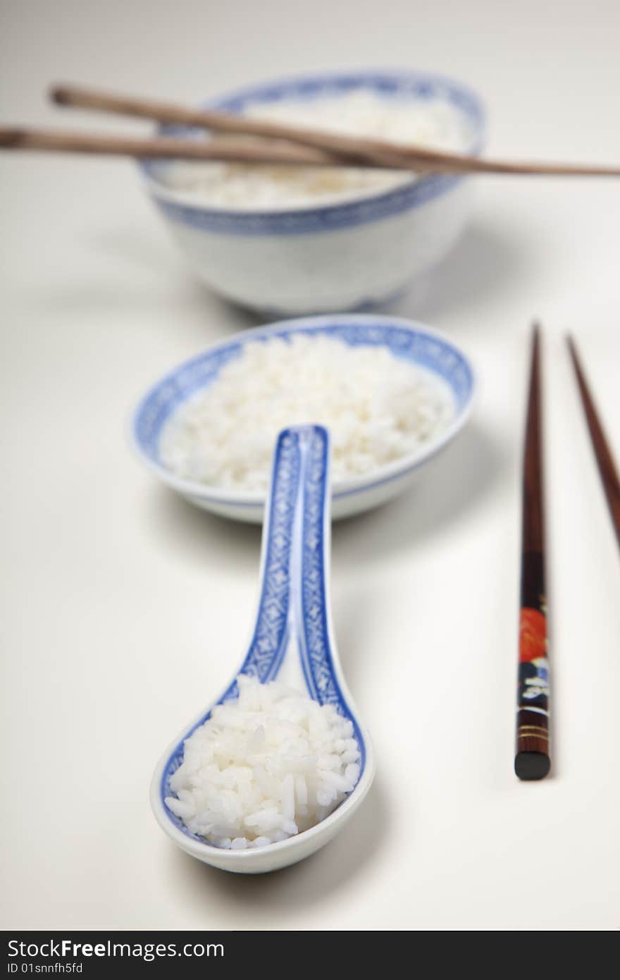 A bowl of perfectly cooked, plain Basmati rice, in an Asian style bowl, with a garnish of Thai Basil. A bowl of perfectly cooked, plain Basmati rice, in an Asian style bowl, with a garnish of Thai Basil