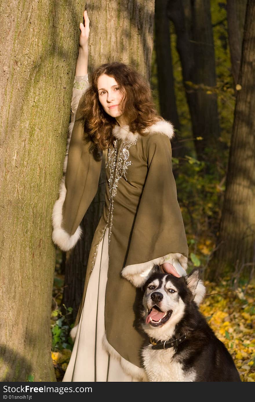 Lady in medieval dress and dog in the forest. Lady in medieval dress and dog in the forest