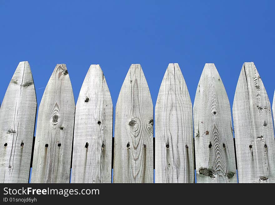 Wooden fence in a blue sky