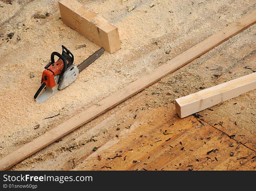 A chain saw at a construction area. A chain saw at a construction area.