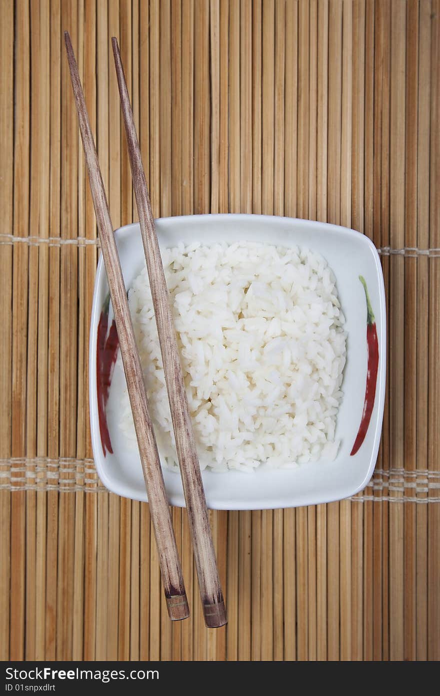 A bowl of perfectly cooked, plain Basmati rice, in an Asian style bowl, with a garnish of Thai Basil. A bowl of perfectly cooked, plain Basmati rice, in an Asian style bowl, with a garnish of Thai Basil