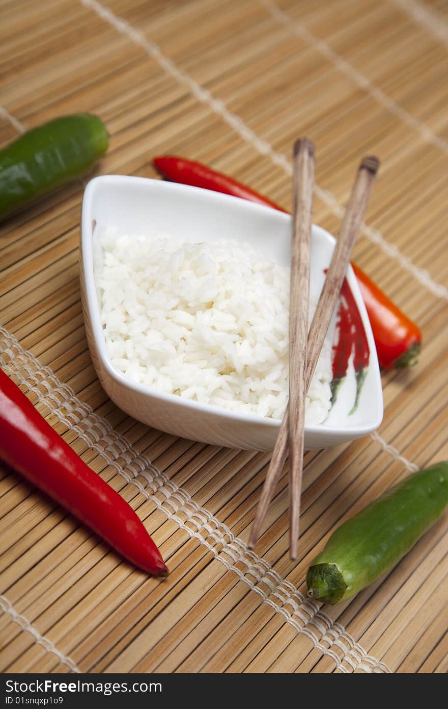 A bowl of perfectly cooked, plain Basmati rice, in an Asian style bowl, with a garnish of Thai Basil. A bowl of perfectly cooked, plain Basmati rice, in an Asian style bowl, with a garnish of Thai Basil