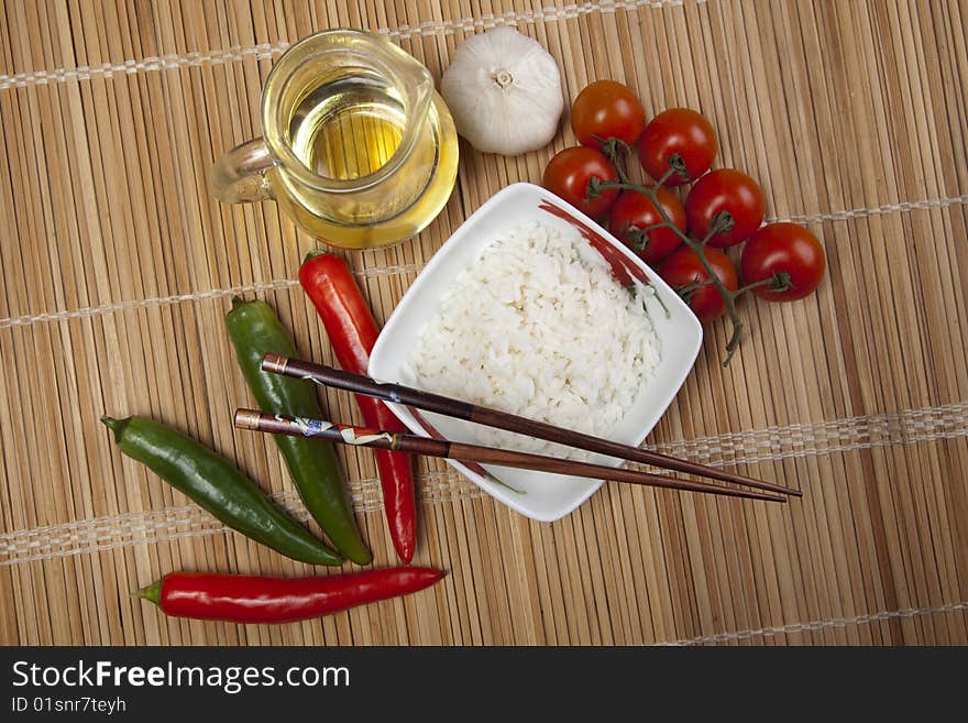 A bowl of perfectly cooked, plain Basmati rice, in an Asian style bowl, with a garnish of Thai Basil. A bowl of perfectly cooked, plain Basmati rice, in an Asian style bowl, with a garnish of Thai Basil