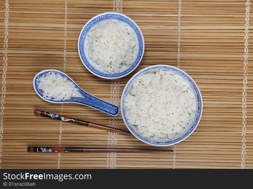 A bowl of perfectly cooked, plain Basmati rice, in an Asian style bowl, with a garnish of Thai Basil. A bowl of perfectly cooked, plain Basmati rice, in an Asian style bowl, with a garnish of Thai Basil