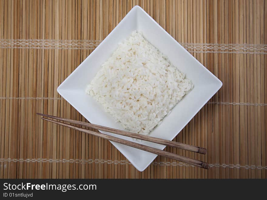 A bowl of perfectly cooked, plain Basmati rice, in an Asian style bowl, with a garnish of Thai Basil. A bowl of perfectly cooked, plain Basmati rice, in an Asian style bowl, with a garnish of Thai Basil