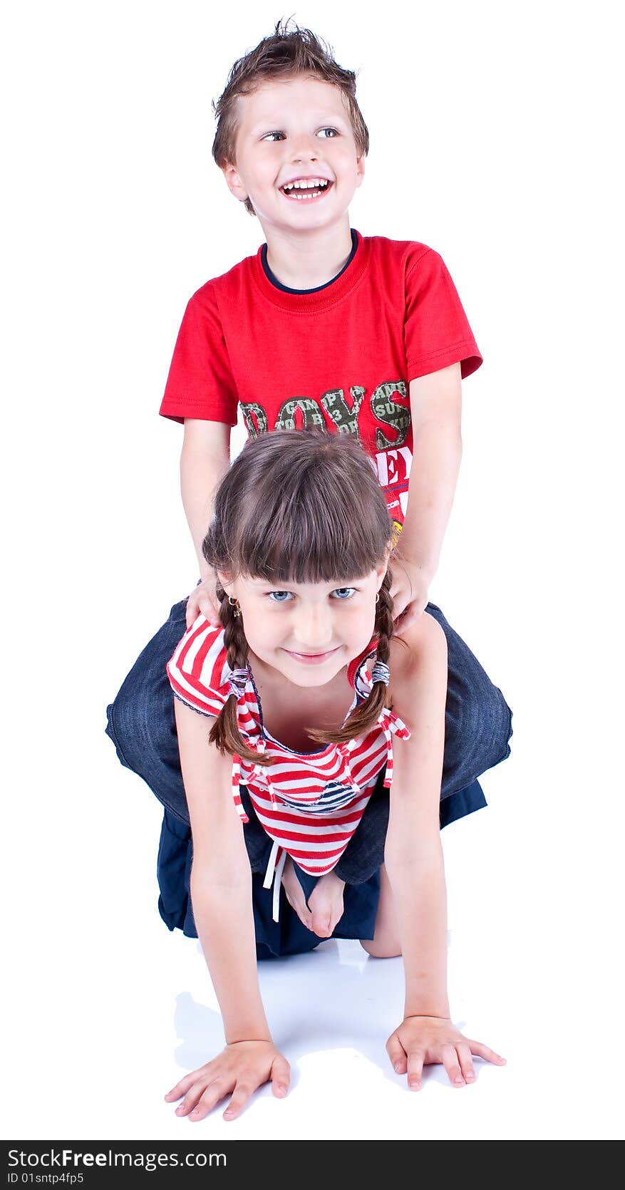 Cute blue-eyed children are playing and posing in studio