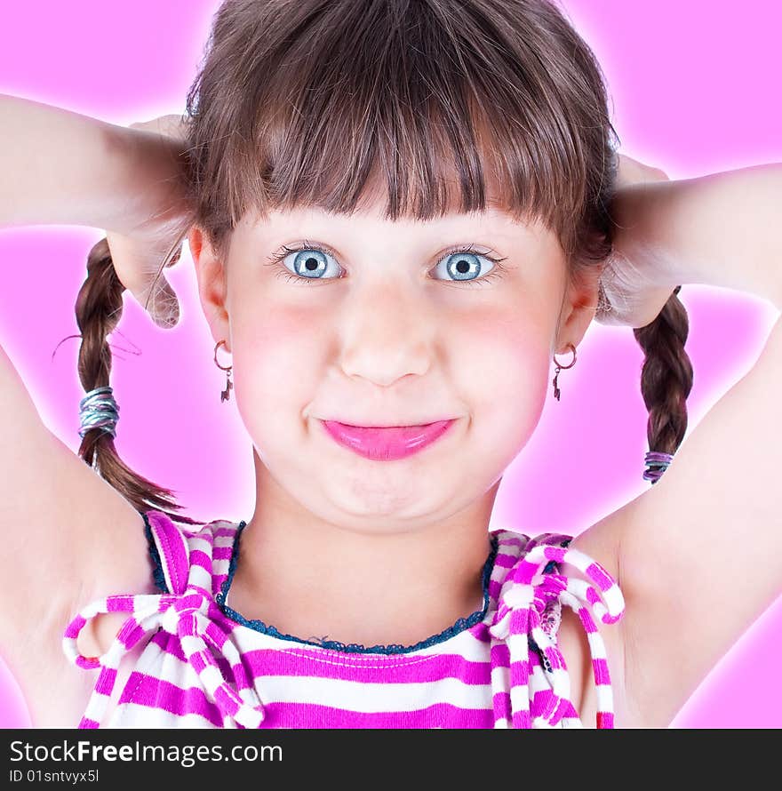 Cute little blue eyed girl making grimace, studio shot