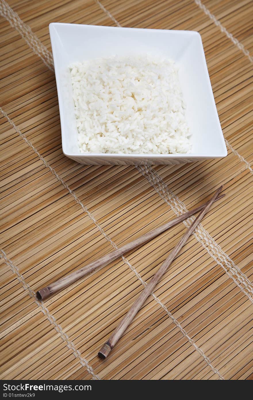 A bowl of perfectly cooked, plain Basmati rice, in an Asian style bowl, with a garnish of Thai Basil. A bowl of perfectly cooked, plain Basmati rice, in an Asian style bowl, with a garnish of Thai Basil