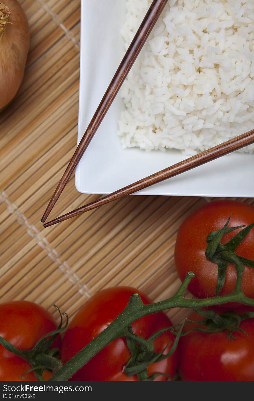 A bowl of perfectly cooked, plain Basmati rice, in an Asian style bowl, with a garnish of Thai Basil. A bowl of perfectly cooked, plain Basmati rice, in an Asian style bowl, with a garnish of Thai Basil