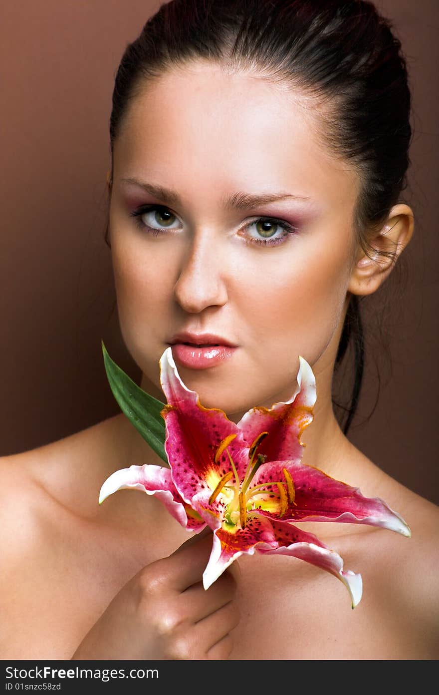 Beauty portrait of a young woman with a lily flower. Beauty portrait of a young woman with a lily flower